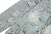 Distressed blue denim jacket with unique skull skeleton design patches.