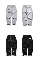 VantageGo streetwear joggers in gray and black with pocket details.