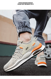 Low-top men's sneakers with breathable Flyknit upper and flat PVC sole, featuring orange and beige accents.