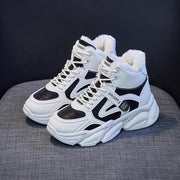 Fleece-lined women's clunky high top sneakers in black and white with front lace-up design.