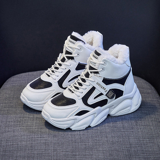 Fleece-lined women's clunky high top sneakers in black and white with front lace-up design.