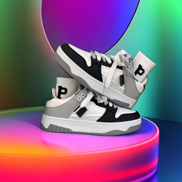 Casual sneakers with a black and white design displayed against a colorful background.
