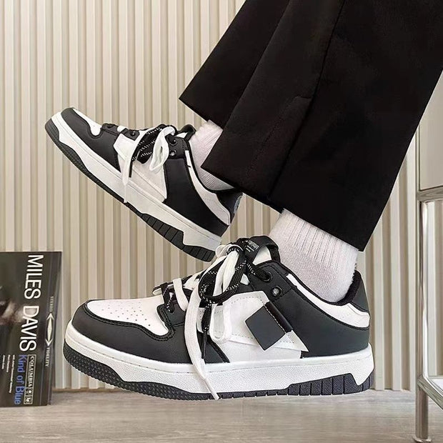 Casual sneakers with black and white leather stitching, round toe, and lace-up front.