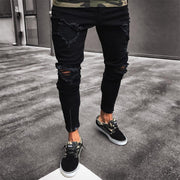 Streetwear ripped jeans in black with multiple tears and a modern fit.