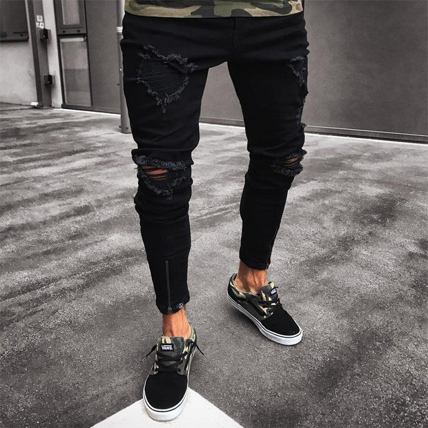 Streetwear ripped jeans in black with multiple tears and a modern fit.