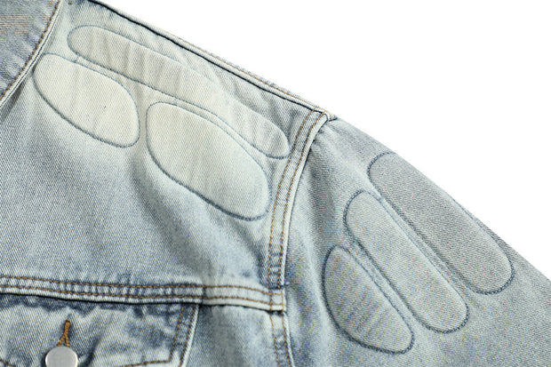 Blue denim jacket with quilted patches on the shoulder, made for men with a skull design theme.