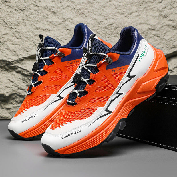 Men's colorblock sneakers in orange, black, and white with PU mesh upper, rubber sole, and flat heel for outdoor activities.