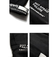 Close-up view of VantageGo streetwear joggers, featuring unique text details on black cotton fabric.