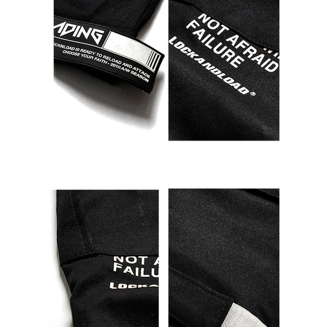 Close-up view of VantageGo streetwear joggers, featuring unique text details on black cotton fabric.