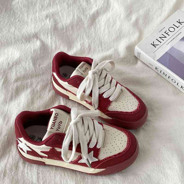 Retro platform star pattern sneakers in burgundy for women on a white surface.