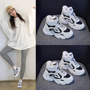 Fleece-lined clunky sneakers for women, warm high top design, lace-up front, shown in black and white with rubber sole.
