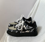 Men's platform sneakers with unique cashew flower pattern, low-top design, and lace-up closure.